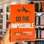 Cover of Do the Impossible by Thibaut Meurisse, featuring bold white text on an orange background with mountain graphics.