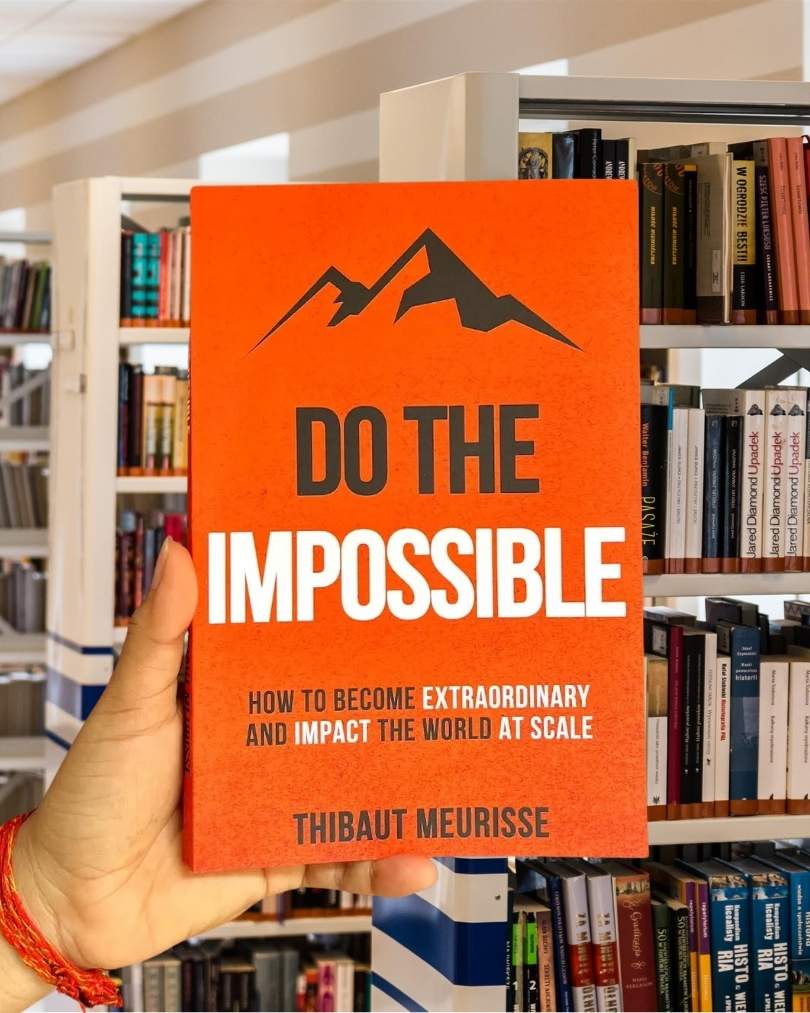 Cover of Do the Impossible by Thibaut Meurisse, featuring bold white text on an orange background with mountain graphics.