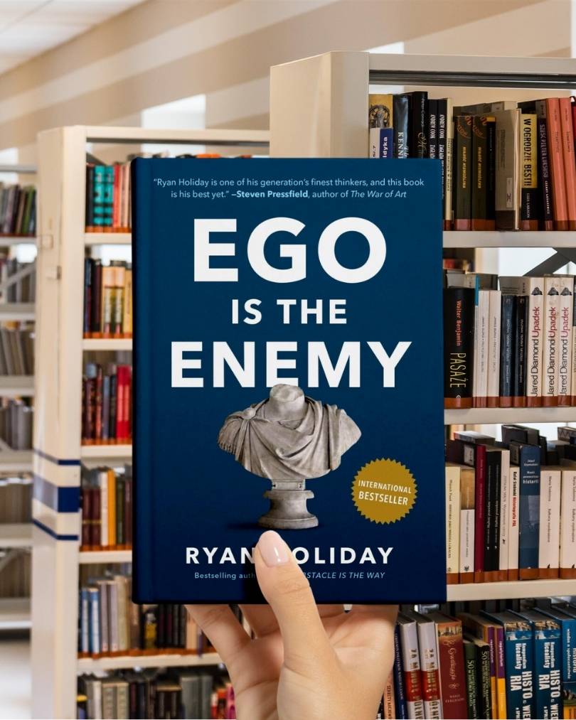 Cover of the book Ego Is the Enemy by Ryan Holiday featuring bold white text on a dark blue background with a Roman bust.