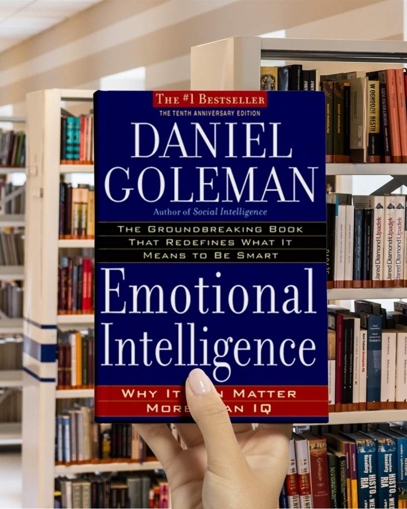 Cover of "Emotional Intelligence" by Daniel Goleman, featuring bold red and blue text on a white background.