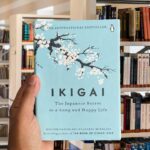 Cover of the book "Ikigai: The Japanese Secret to a Long and Happy Life" by Héctor García and Francesc Miralles, featuring a light blue background with a delicate cherry blossom tree.