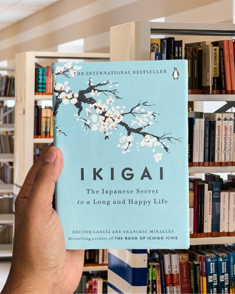 Cover of the book "Ikigai: The Japanese Secret to a Long and Happy Life" by Héctor García and Francesc Miralles, featuring a light blue background with a delicate cherry blossom tree.