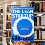 Cover of 'The Lean Startup' by Eric Ries with a blue background, white text, and a circular brushstroke design.