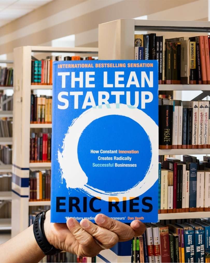 Cover of 'The Lean Startup' by Eric Ries with a blue background, white text, and a circular brushstroke design.