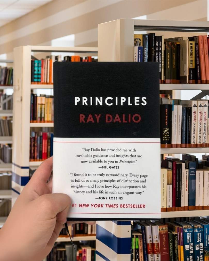 Cover of the book “Principles” by Ray Dalio, featuring a black background with bold red and white typography.