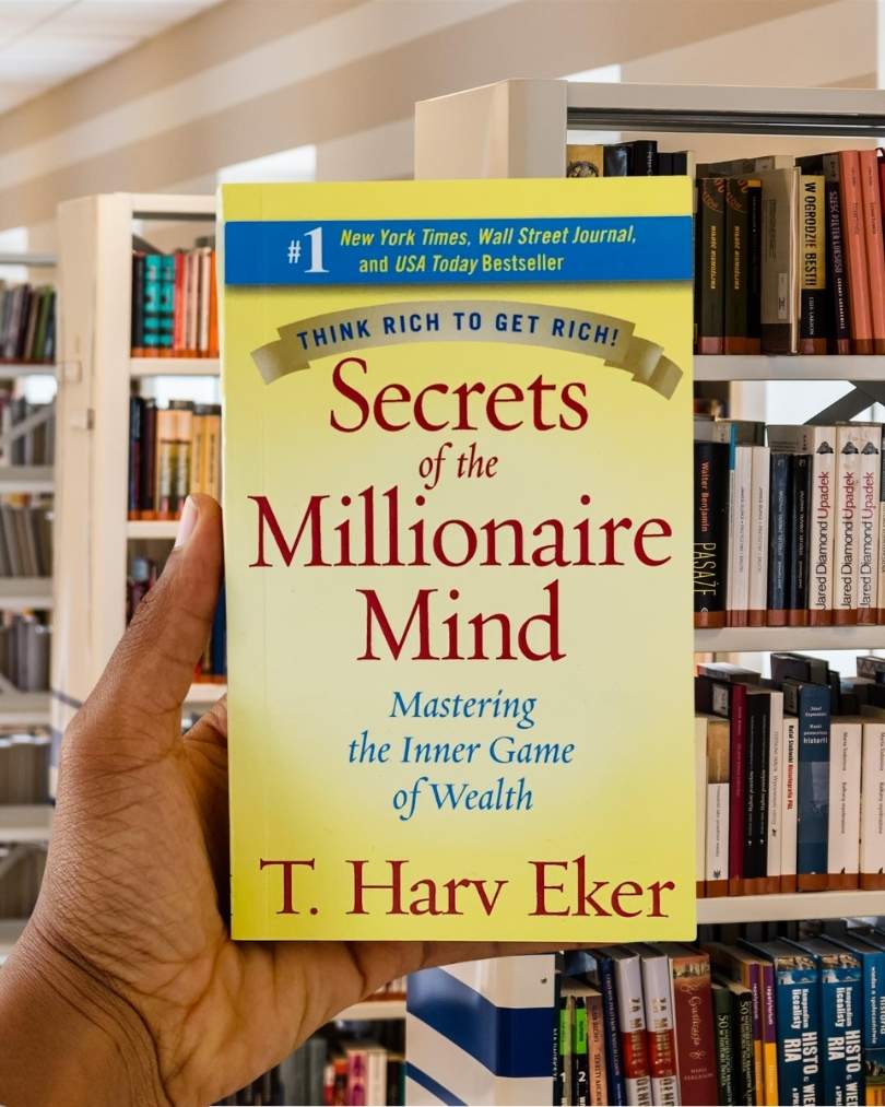 Cover of Secrets of the Millionaire Mind by T. Harv Eker, featuring a bold yellow and blue design with the subtitle: "Mastering the Inner Game of Wealth."