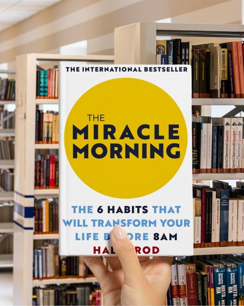 Cover of "The Miracle Morning" by Hal Elrod, featuring a sunrise and a silhouette of a person raising their arms.