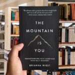 Cover of The Mountain Is You by Brianna Wiest, featuring a minimalist design with mountain imagery and a calm, neutral color palette.