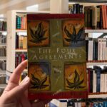 Cover of "The Four Agreements" by Don Miguel Ruiz, featuring colorful Toltec-inspired artwork.