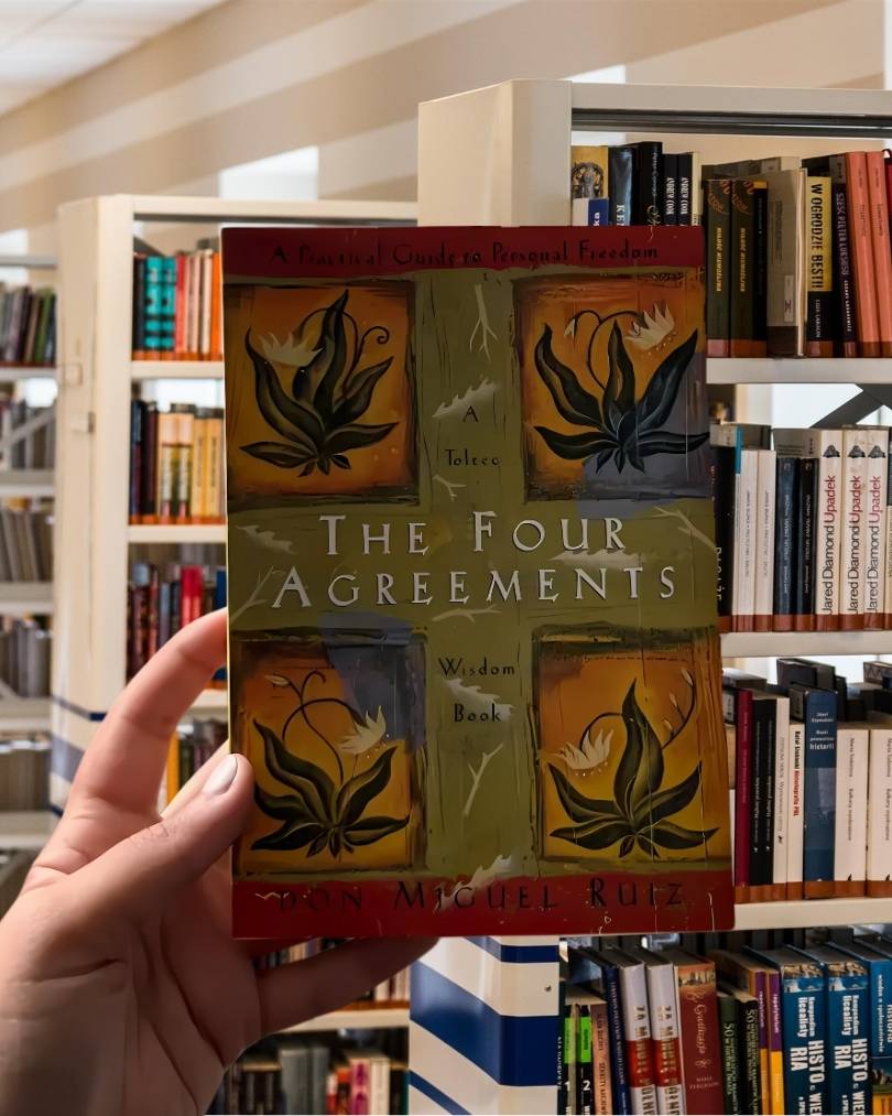 Cover of "The Four Agreements" by Don Miguel Ruiz, featuring colorful Toltec-inspired artwork.
