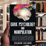 Book cover of “Dark Psychology & Manipulation” featuring a shadowed human silhouette with a web of strings connected to puppet hands.