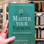 Cover of the book "Master Your Thinking" by Brandon Goleman featuring a dark blue background with a glowing brain illustration.
