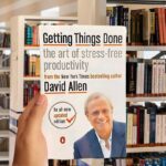 Cover of 'Getting Things Done' by David Allen featuring the author in a suit, smiling, with the book title in bold white letters.