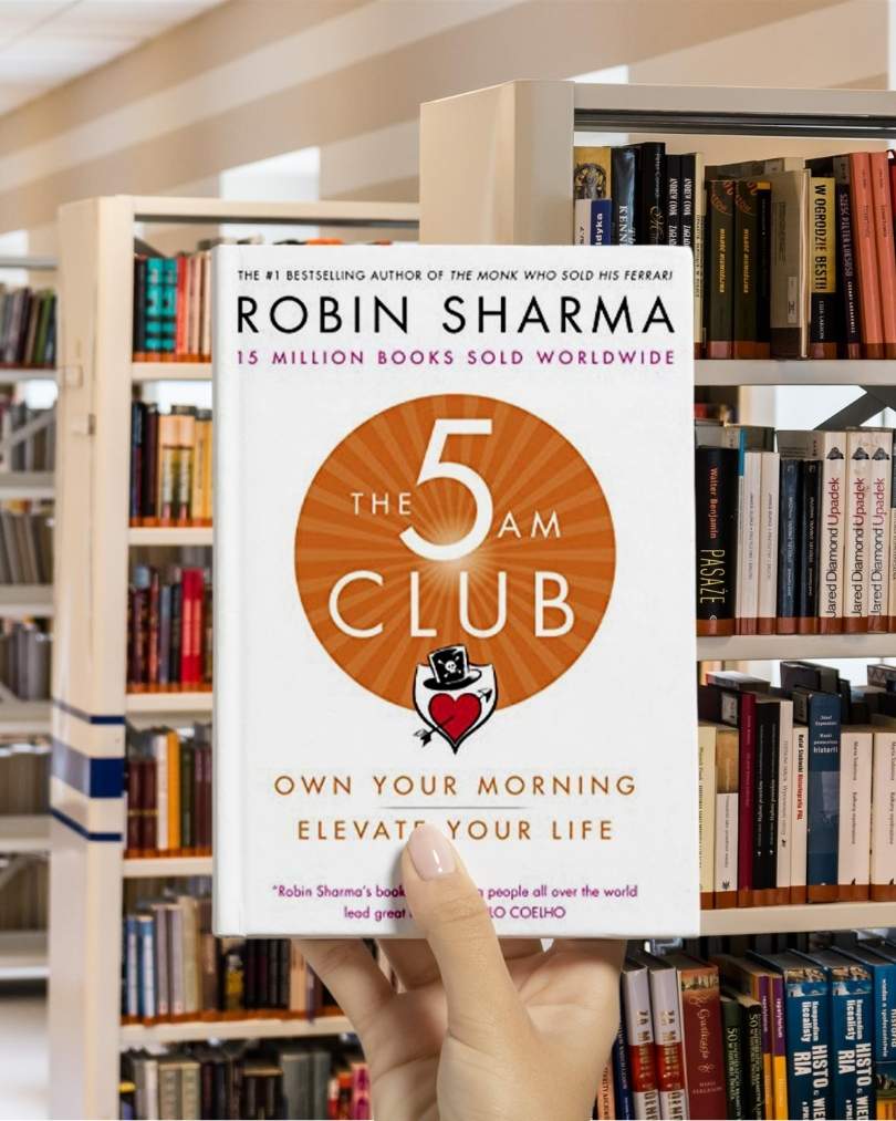 Cover of "The 5 AM Club" book by Robin Sharma, featuring a minimalist red and white design with a clock icon.