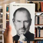 Steve Jobs by Walter Isaacson hardcover book cover featuring Jobs in black turtleneck, hand on chin