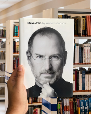 Steve Jobs by Walter Isaacson hardcover book cover featuring Jobs in black turtleneck, hand on chin